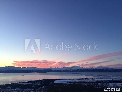 Pink and Blue Mountain Water Logo - Pink sunrise clouds over blue mountains this