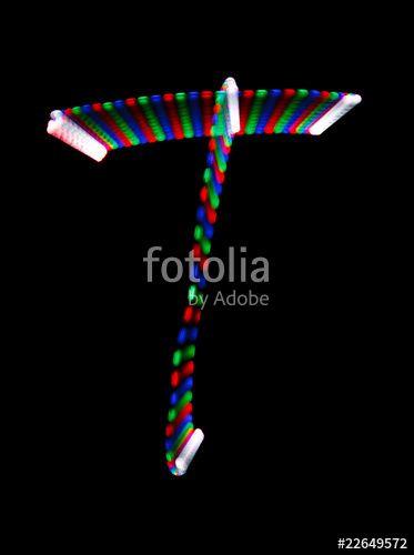 Rainbow Letter T Logo - Bright rainbow letter T on black background. Isolated.