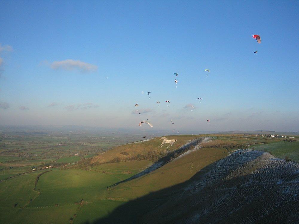 Flying White Horse Logo - Paragliders flying over Westbury White Horse, Wiltshire