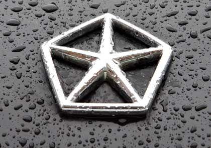 Chrysler Automotive Logo - A Chrysler car logo is pictured on a rain drop covered vehicle in ...