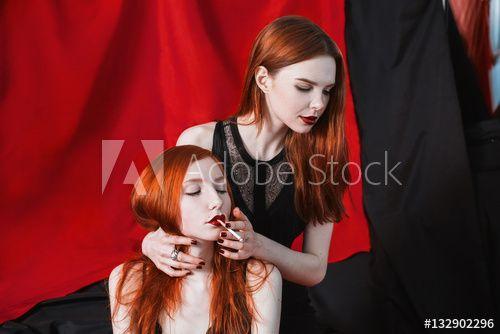 Two Red Girls Logo - Two red-haired girl hugging and smoke on black and red background ...