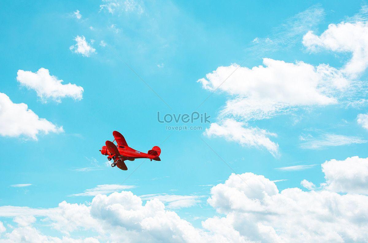 Blue and Red Plane Logo - The red plane in the blue sky and white clouds creative