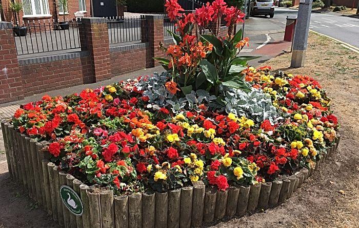Green Flower Red Petal Logo - Rope Lane-Wells Green flower bed - photo by David Clews - Nantwich News