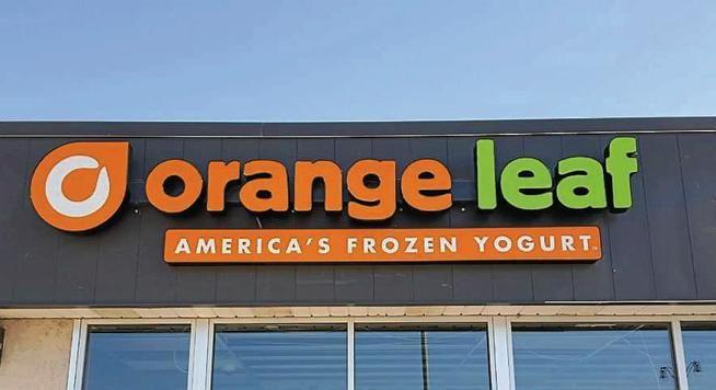 Orange Leaf America Frozen Logo - Couple bringing treat to West Main Street - Journal Advocate