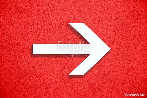 Red and White Arrow Logo - White arrow direction sign over vivid bright red color stucco rough ...
