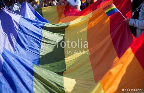 Person Holding Rainbow Logo - people holding giant rainbow flag at pride parade - LGBT symbol ...