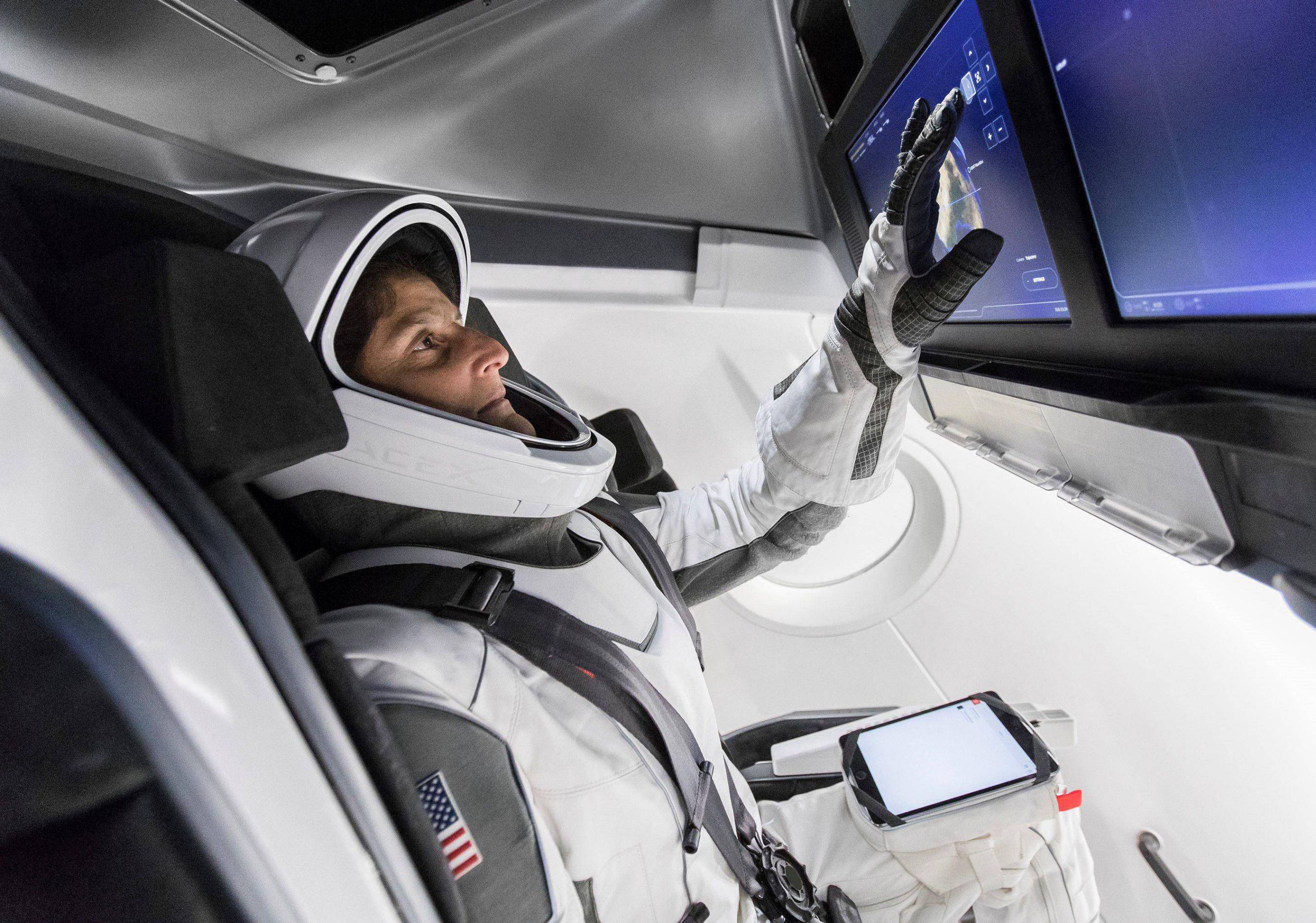 NASA Dragon Logo - SpaceX releases photo of NASA astronauts testing in Crew Dragon ...