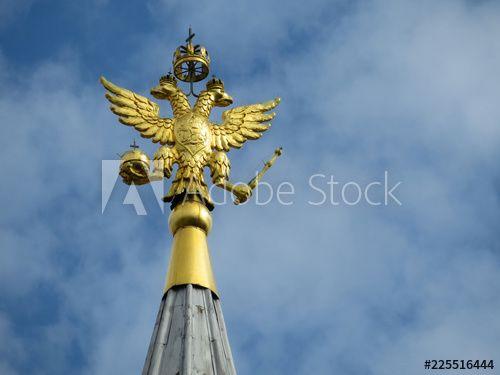 Eagle in Red Square Logo - Coat of arms of Russia on blue sky with clouds. Golden Imperial ...