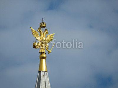 Eagle in Red Square Logo - Coat of arms of Russia on cloudy sky. Golden Imperial eagle, Russian