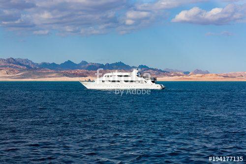 Wave and Red Mountain Logo - White yacht is on the wave. Blue sea and sky. Red mountain.