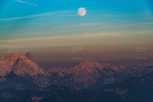 Pink White and Blue Mountains Logo - Moon is rising just as the sun is setting. Beautiful scene on our