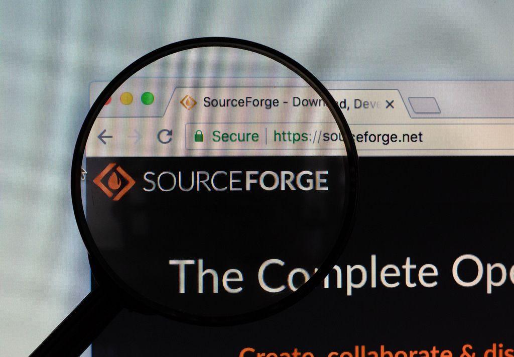 SourceForge Logo - SourceForge logo on a computer screen with a magnifying gl