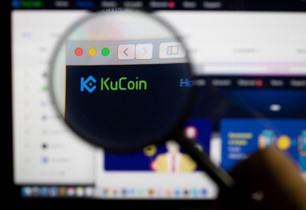 Kucoin Logo - KuCoin logo on a computer screen with a magnifying glass