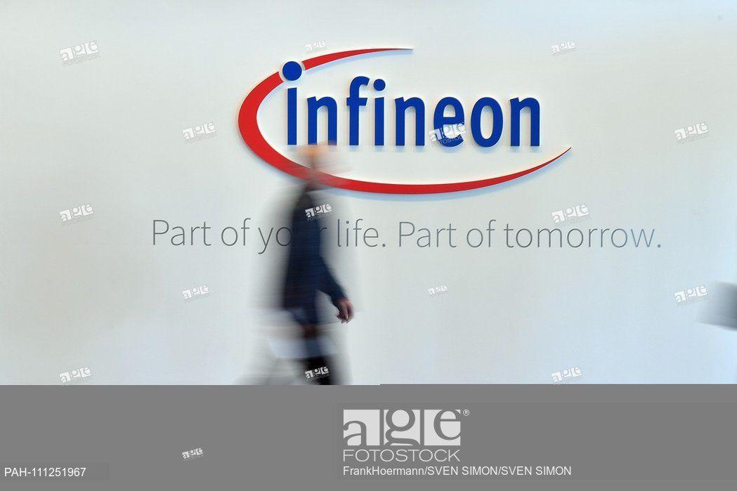 Infineon Logo - Feature, Borders, General-A person walks past the Infineon logo ...