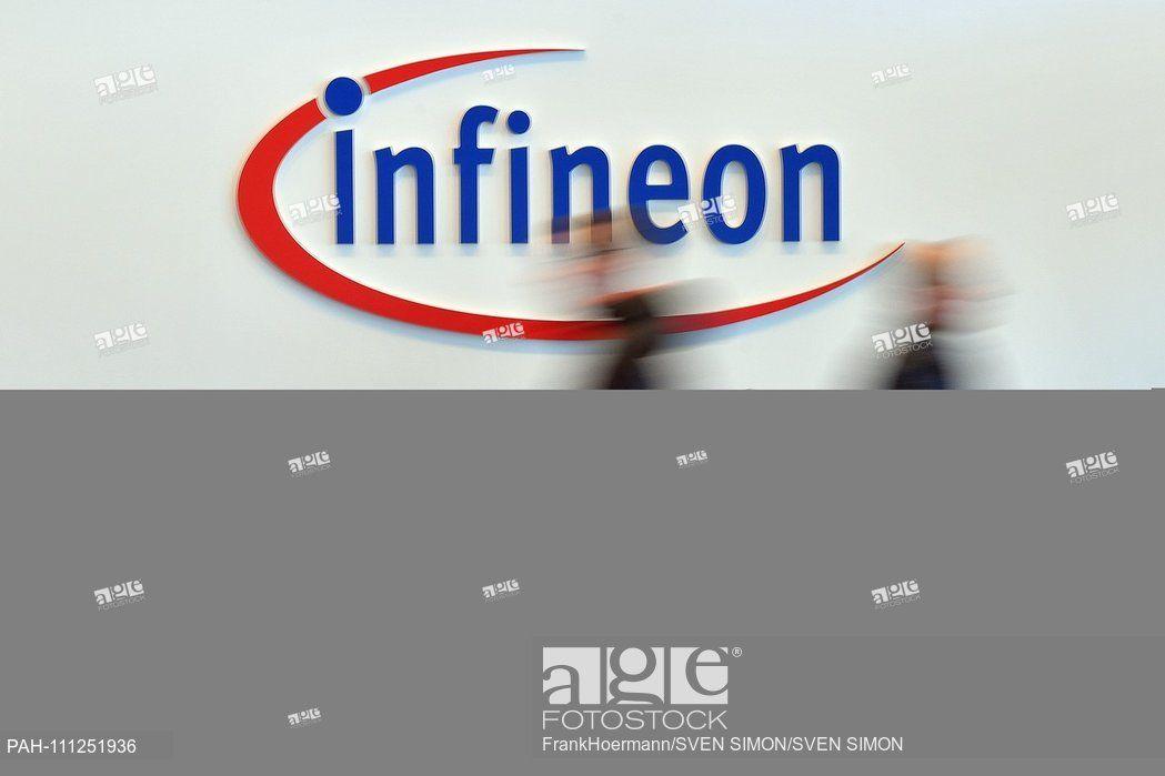 Infineon Logo - Feature, Border, General People walk past the Infineon logo, blurred