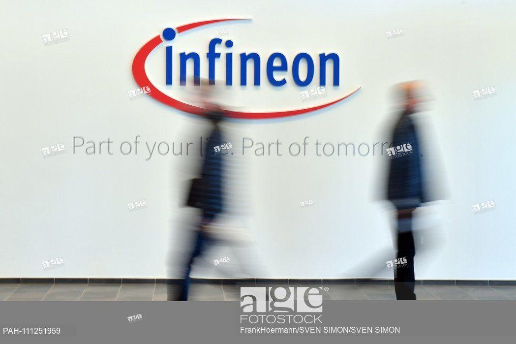 Infineon Logo - Feature, Border, General People walk past the Infineon logo, blurred