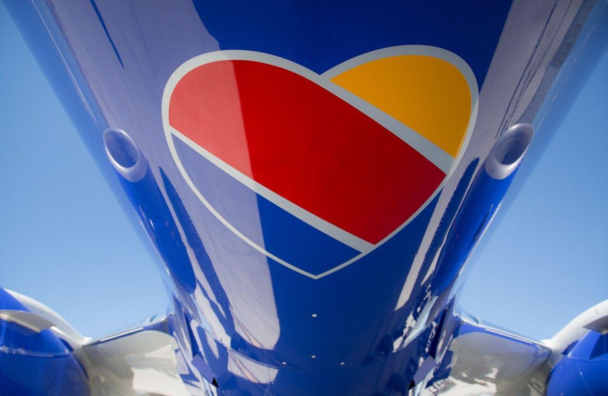 Red and Yellow Plane Logo - Southwest Airlines Unveils New Look Echoing Traditional Image - WSJ