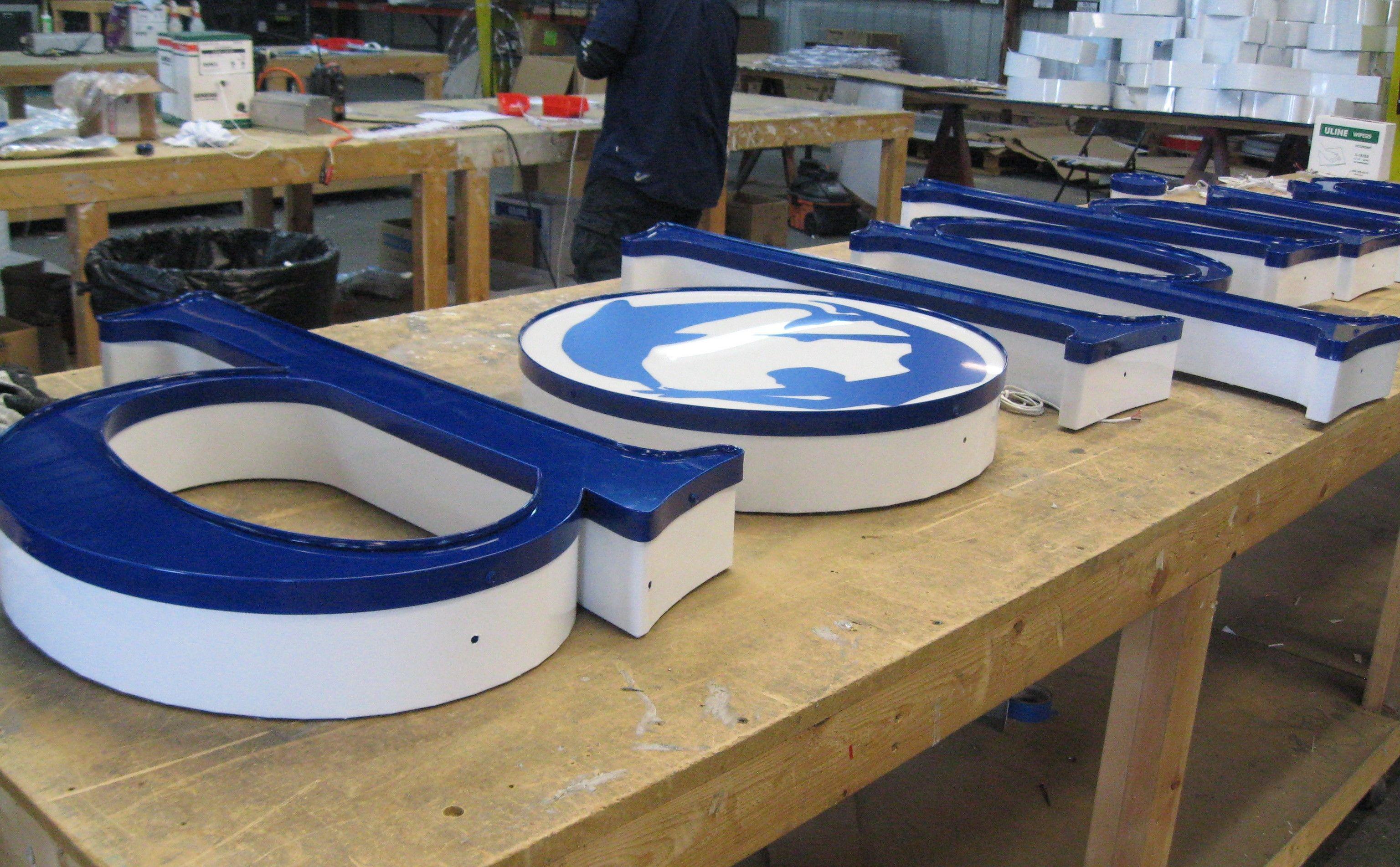 White and Blue Face Logo - LED Channel Letters with Channel Logo. White return, blue trim cap