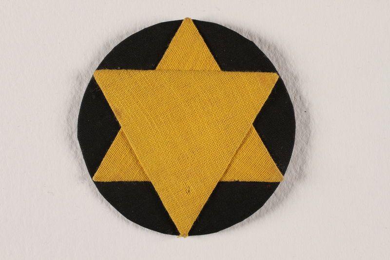 Yellow Star Circle Logo - Star of David badge with a yellow star on a black circle worn by a ...