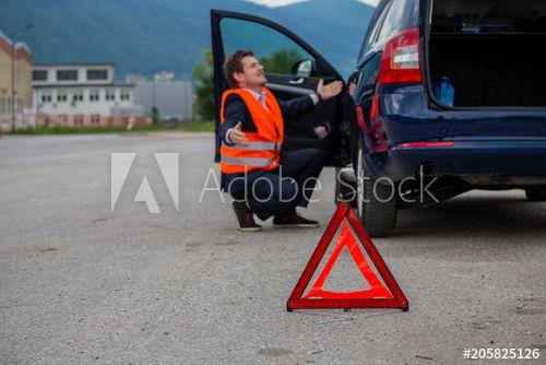 Broken Red Triangle Logo - A broken car on the road, a red triangle of warning on the road, a