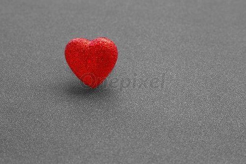 Gray and Red Heart Logo - The red heart shape on dark grey glitter background in