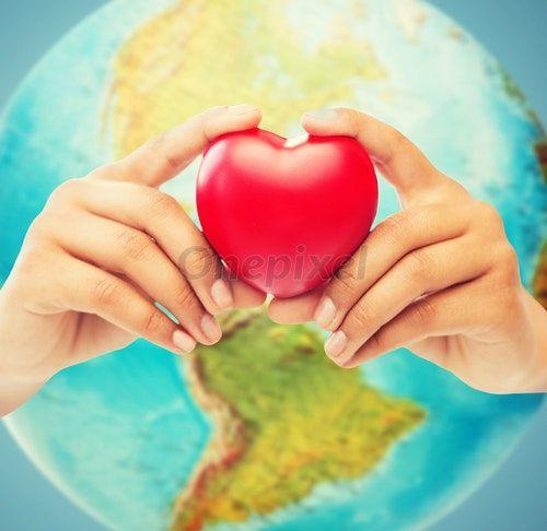 Globe with Red Hands Logo - Woman hands holding red heart over earth globe - 519520 | Onepixel