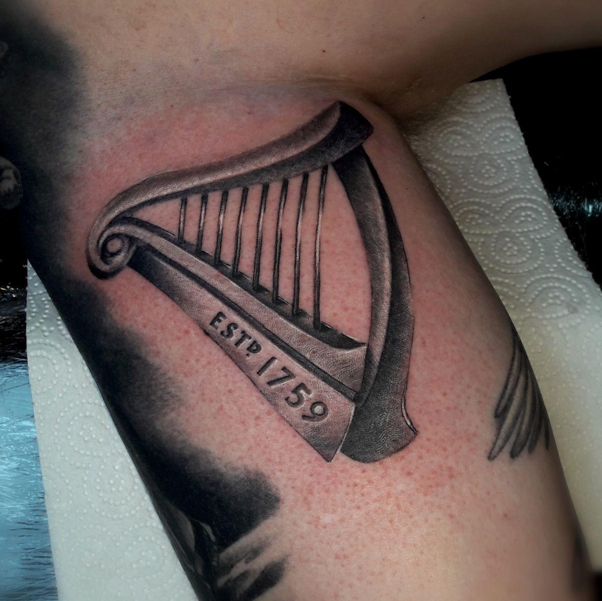 Black Guinness Harp Logo - Irish and Celtic Tattoo - The Black Hat Tattoo