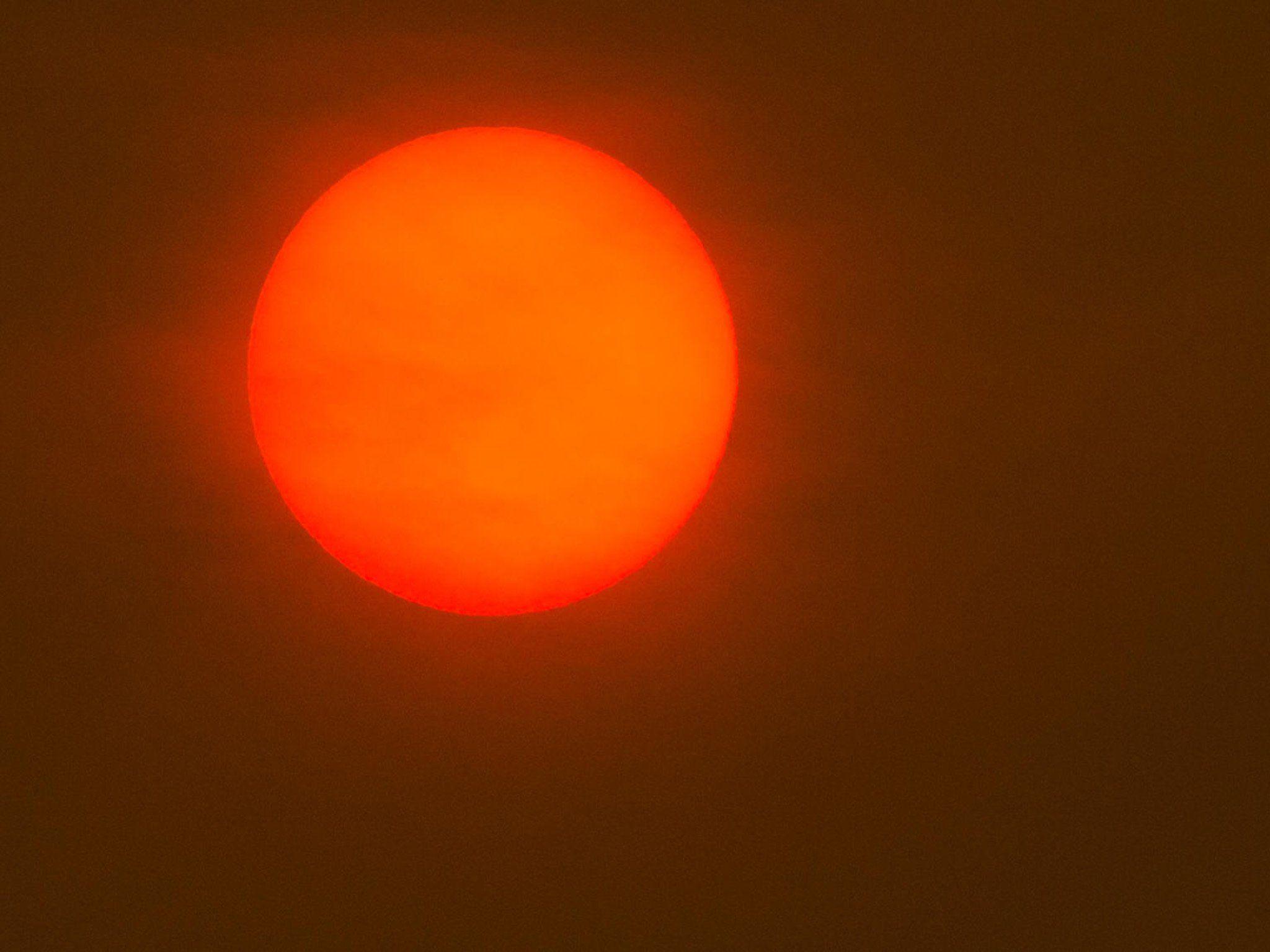 Red and Orange Sun Logo - Red sun spotted in sky over UK as Storm Ophelia whips up dust