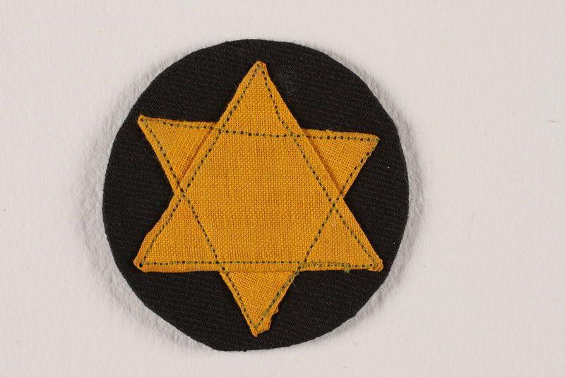 Yellow Star Circle Logo - Badge with a yellow Star of David on a black circle worn by a ...