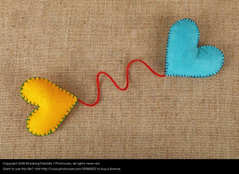 Red Yellow Heart Logo - Two handmade felt craft hearts yellow and blue on canvas Royalty