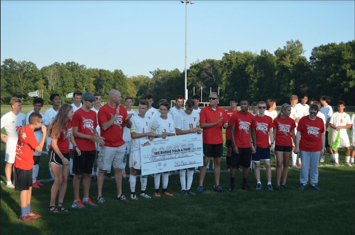 Fishers High School F Logo - Boys soccer presents check to unified track and field team