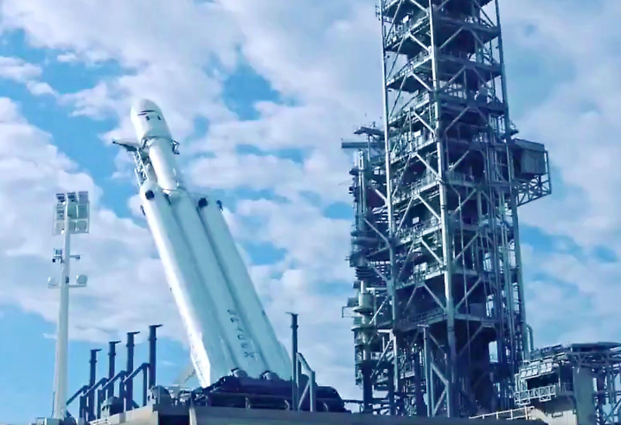 Verical SpaceX Falcon Heavy Logo - Musk shares timelapse of SpaceX Falcon Heavy being raised for launch