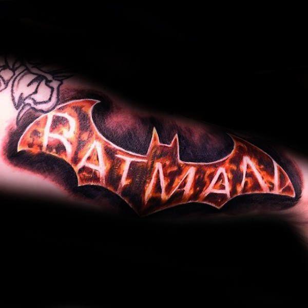 Watercolor Batman logo tattoo on the right inner arm.