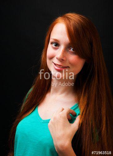 Woman with Red Hair Flowing Logo - Young girl with flowing red hair on a black background