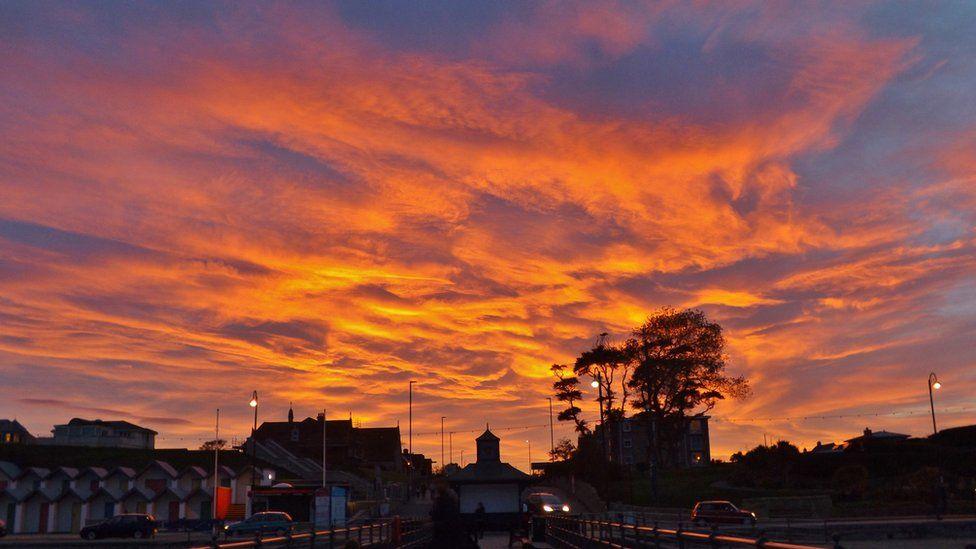 Red and Orange Sunset Logo - Spectacular sunsets light up UK skies
