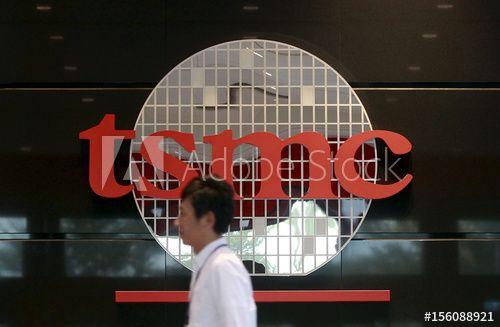 Similar TSMC Logo - An employee walks in front of logo of Taiwan Semiconductor