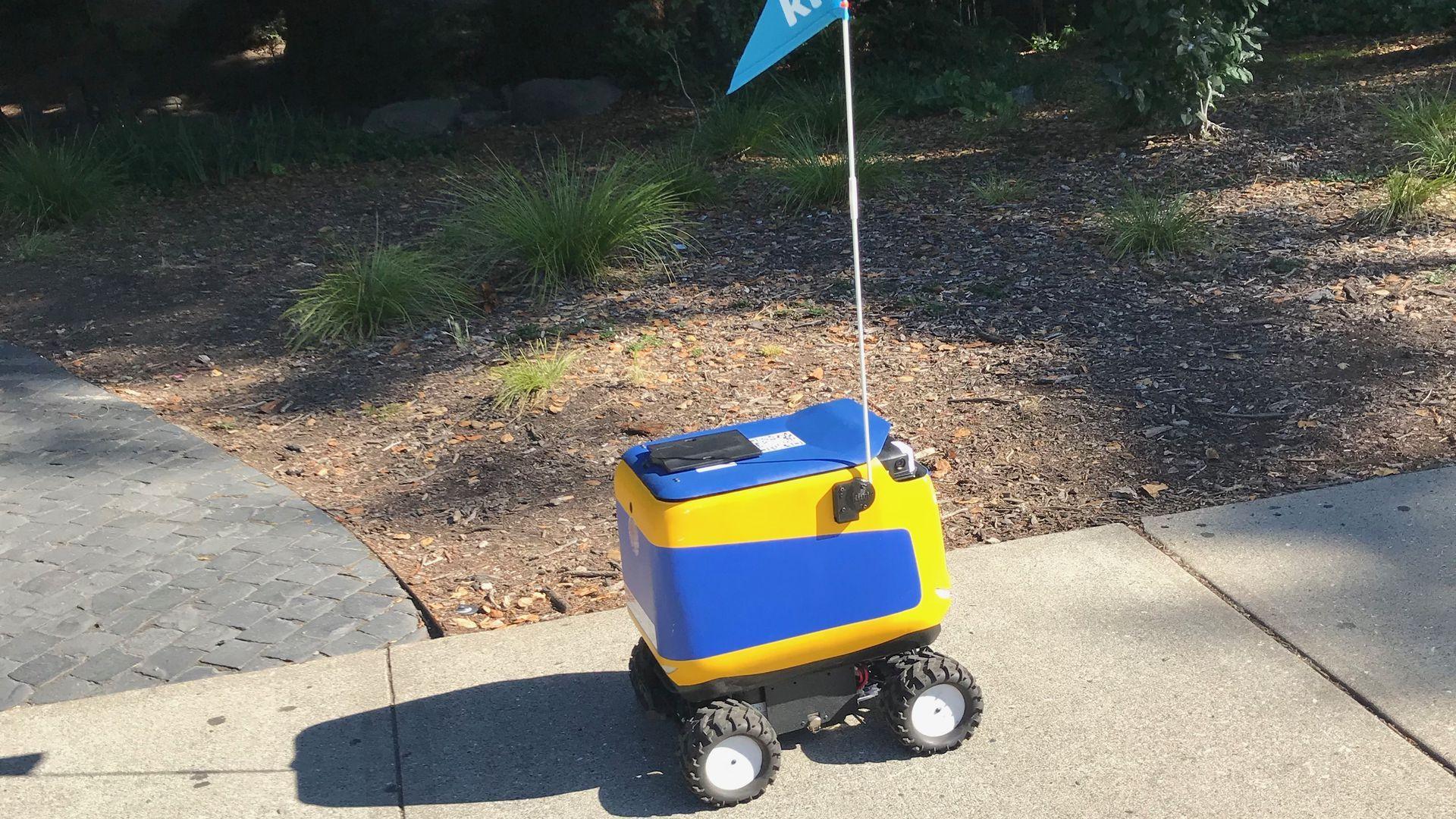 Robot with Yellow Food Logo - Kiwi's food delivery robots will soon be hitting a sidewalk near you