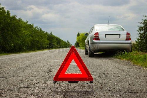 Red Triangle Car Logo - Red triangle of a car on the road. Car warning