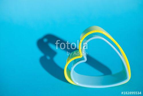 Blue and Yellow Heart Logo - Blue and yellow heart shape on blue background, love symbol Stock