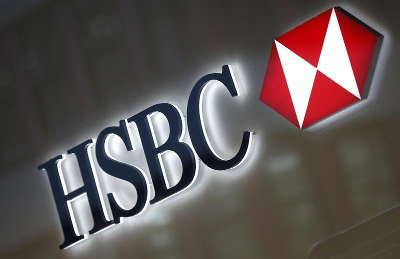 HSBC New Logo - A HSBC logo is seen above the entrance to a HSBC bank branch in New