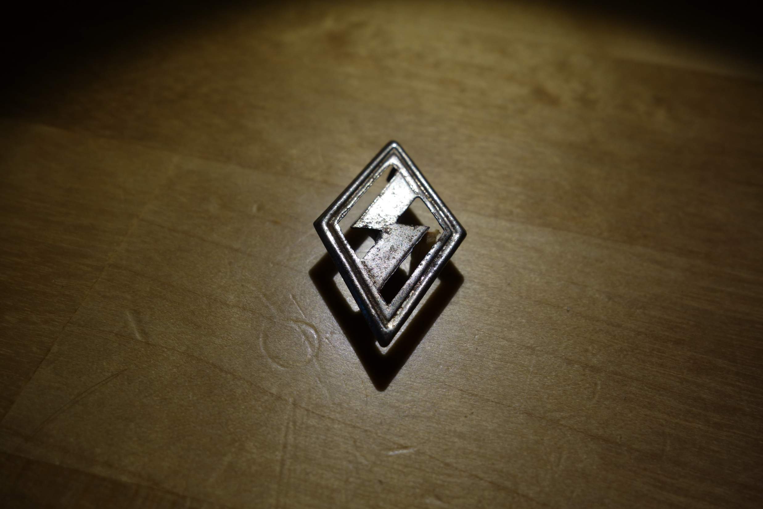 Silver Diamond Shape Logo - Unknown small diamond shape logo with safety pin?