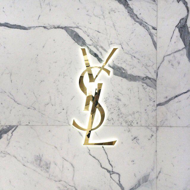 YSL Logo - YSL logo in brass on carrara marble close up detail. Signs