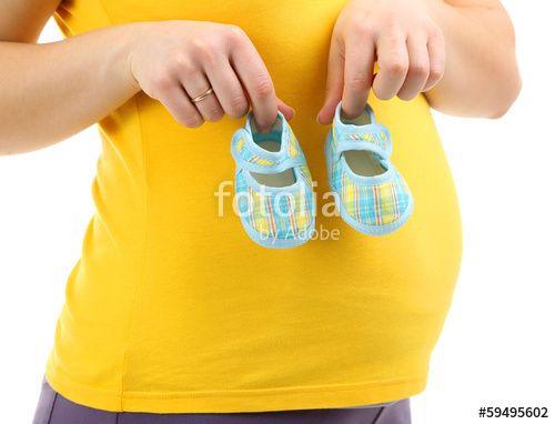 Woman Holding Baby Blue Logo - Pregnant woman holding blue baby shoes isolated on white Stock