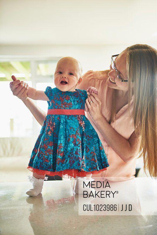 Woman Holding Baby Blue Logo - Mediabakery - Photo by Cultura Images - Woman holding hands with ...