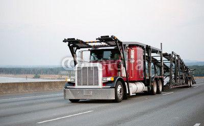 Red Classic Transportation Logo - Red classic big rig semi truck with car hauler trailer running by ...