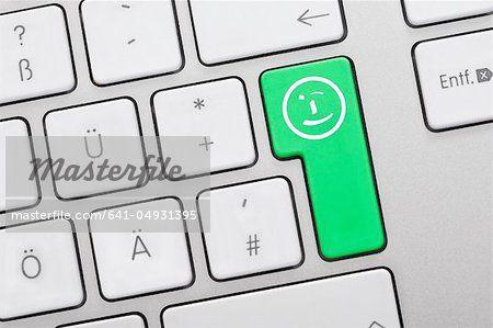 Comuter Green Face Logo - Close up of computer keys with smiley face symbol on green key ...