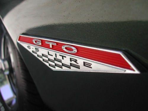 Pontiac GTO Logo - Extreme closeup of the logo of a Pontiac GTO in black or dark grey ...