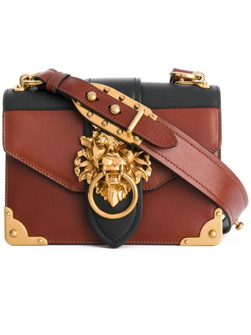 Purse with Lion Logo - Prada Cahier Lion Embellished Shoulder Bag In Brown