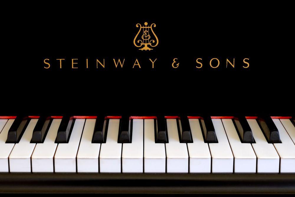 Gold Piano Logo - Steinway & Sons logo close up. Classic gold lettering above the ...