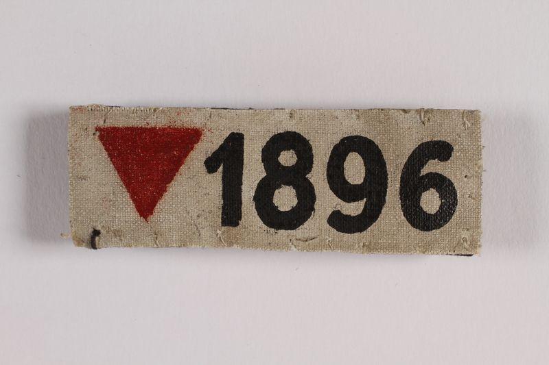 Red Triangle House Logo - White badge with an inverted red triangle and number 1896 worn by a ...
